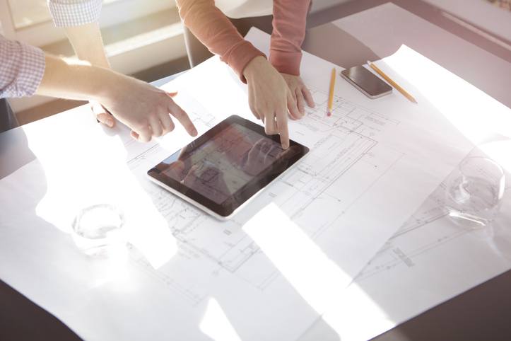 Business people discussing plans on tablet