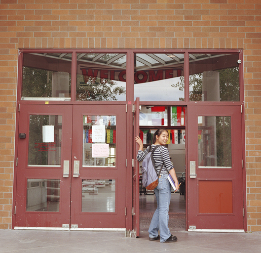 A young woman entering the building
