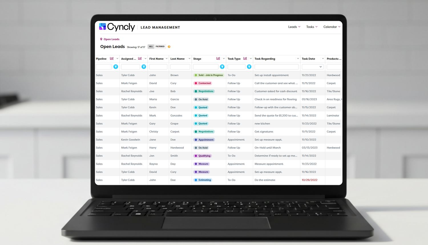 Cyncly lead management interface on a laptop screen showing an organized list of sales leads with statuses, assigned reps, and task details.