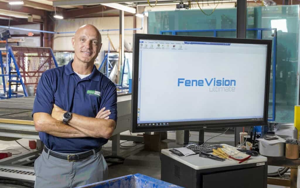 A man stands before a large screen displaying "FeneVision" logo